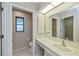 Bathroom with a vanity sink, mirror, and toilet with a window at 20431 Calder Ave, Port Charlotte, FL 33954