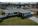 Well-maintained single-story home featuring a lush green lawn and attached two-car garage at 20431 Calder Ave, Port Charlotte, FL 33954