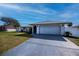 Well-kept single-story home featuring an attached two-car garage, green lawn, and manicured landscaping at 20431 Calder Ave, Port Charlotte, FL 33954