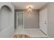 Bright foyer with tile flooring, decorative lighting, and open doorways leading to other rooms at 20431 Calder Ave, Port Charlotte, FL 33954