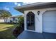 Close up of the front entrance showcasing landscaped flower beds and the home's address at 20431 Calder Ave, Port Charlotte, FL 33954