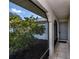 Enclosed front porch with tiled floor offering a shaded entryway and view of the landscaped yard at 20431 Calder Ave, Port Charlotte, FL 33954