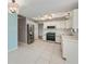 A bright kitchen features stainless steel appliances, white cabinetry, and tile floors at 20431 Calder Ave, Port Charlotte, FL 33954