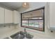 Kitchen sink below a window offering a view of the lanai and pool at 20431 Calder Ave, Port Charlotte, FL 33954