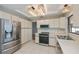 Bright kitchen featuring stainless steel appliances, white cabinets and a window with a pool view at 20431 Calder Ave, Port Charlotte, FL 33954