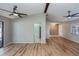 Spacious living room with vaulted ceilings, ceiling fans, wood flooring, and views into other rooms at 20431 Calder Ave, Port Charlotte, FL 33954