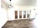 Dining area with hardwood floors and French doors leading to the backyard at 21157 Midway Blvd, Port Charlotte, FL 33952