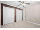 Bedroom with a ceiling fan, closet, and wood accent wall at 21274 Gladis Ave, Port Charlotte, FL 33952