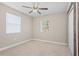 Bright bedroom featuring a ceiling fan, natural light, and closet space at 21274 Gladis Ave, Port Charlotte, FL 33952