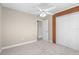 Bedroom with neutral colors, ceiling fan, closet, and an ensuite bathroom entrance at 21274 Gladis Ave, Port Charlotte, FL 33952