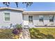 Inviting front entrance with well-maintained landscaping and a freshly painted exterior at 21274 Gladis Ave, Port Charlotte, FL 33952