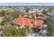 Aerial view of single-Gathering home with orange tile roof, showcasing neighborhood and waterfront at 21370 Harborside Blvd, Port Charlotte, FL 33952