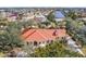 Aerial view of single-Gathering house with orange tile roof and lush landscaping at 21370 Harborside Blvd, Port Charlotte, FL 33952