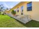 Backyard patio with steps leading up to the house and potted plants at 21370 Harborside Blvd, Port Charlotte, FL 33952