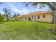 Backyard of single-Gathering home featuring a grassy lawn and patio area at 21370 Harborside Blvd, Port Charlotte, FL 33952