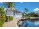 Elegant clubhouse featuring waterfront views, a charming walkway, and lush landscaping at 21370 Harborside Blvd, Port Charlotte, FL 33952