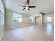 Bedroom boasts tiled floors, ceiling fans, and a closet, with natural light from two windows at 21402 Meehan Ave, Port Charlotte, FL 33952