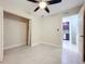 Bedroom featuring tiled floors, an open closet, neutral walls, and natural light at 21402 Meehan Ave, Port Charlotte, FL 33952