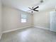 Bedroom features tiled floors, neutral walls, a closet, and natural light from a window at 21402 Meehan Ave, Port Charlotte, FL 33952