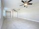 Spacious bedroom featuring tiled floors, neutral walls, dual ceiling fans, and a convenient closet at 21402 Meehan Ave, Port Charlotte, FL 33952