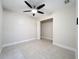 Bedroom features tiled floors, an open closet, ceiling fan, and neutral walls at 21402 Meehan Ave, Port Charlotte, FL 33952