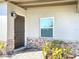 Stylish front door with decorative stone accents and manicured landscaping detail at 21402 Meehan Ave, Port Charlotte, FL 33952