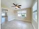 Bright room boasts tiled floors, neutral walls, and natural light and an open floor plan at 21402 Meehan Ave, Port Charlotte, FL 33952