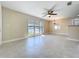 Spacious living area featuring tile flooring, natural light, and a modern ceiling fan at 21402 Meehan Ave, Port Charlotte, FL 33952