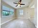 Bright living room featuring tiled floors, ceiling fan, natural light, and neutral walls at 21402 Meehan Ave, Port Charlotte, FL 33952