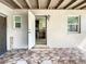 Outdoor patio leading to a kitchen with dark cabinets, microwave, stove and range hood at 21402 Meehan Ave, Port Charlotte, FL 33952