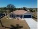 An aerial view of single Gathering home with a well-manicured lawn and a long driveway at 2275 Logsdon St, North Port, FL 34287