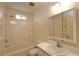 Bathroom features a bathtub and shower combination, toilet, and vanity with sink at 2275 Logsdon St, North Port, FL 34287