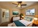 Bright bedroom features a ceiling fan, a window, and a doorway to another room at 2275 Logsdon St, North Port, FL 34287