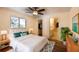 Bedroom with ceiling fan, view of ensuite bathroom and closet, as well as natural light at 2275 Logsdon St, North Port, FL 34287