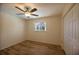 Bright bedroom featuring a ceiling fan, wood flooring, and a convenient closet at 2275 Logsdon St, North Port, FL 34287