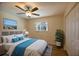 Bedroom with ceiling fan, a window overlooking neighborhood, and walk-in closet at 2275 Logsdon St, North Port, FL 34287