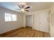 Bedroom features a ceiling fan, wood flooring, closet, and a bright window at 2275 Logsdon St, North Port, FL 34287