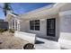 Inviting front porch with decorative stone accents and a modern navy-colored front door at 2275 Logsdon St, North Port, FL 34287