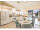 Bright kitchen featuring white cabinetry, modern appliances, and a view of the outdoor pool at 2275 Logsdon St, North Port, FL 34287