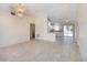 Spacious living room with neutral tile flooring that transitions to the kitchen area at 2275 Logsdon St, North Port, FL 34287