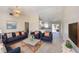 Cozy living room with modern decor featuring navy sofas, a TV, and a view into the kitchen at 2275 Logsdon St, North Port, FL 34287