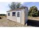 Exterior view of shed with door and two windows in backyard at 2275 Logsdon St, North Port, FL 34287