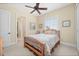 Cozy bedroom with wood-framed bed and access to a shared bathroom at 24248 Treasure Island Blvd, Punta Gorda, FL 33955