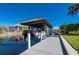 Waterfront property featuring a private boat dock with a covered lift, providing direct access to the water and boating activities at 24248 Treasure Island Blvd, Punta Gorda, FL 33955