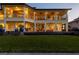 Back exterior of home featuring a large covered patio and lush landscaping at 24248 Treasure Island Blvd, Punta Gorda, FL 33955