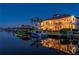 Luxury waterfront home at dusk with private dock and boat at 24248 Treasure Island Blvd, Punta Gorda, FL 33955