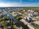 Stunning aerial view of the neighborhood, showing canals, waterways and lush landscaping at 24343 Pirate Harbor Blvd, Punta Gorda, FL 33955