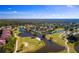 Aerial view of the homes in a golf community with multiple ponds and mature trees at 24343 Pirate Harbor Blvd, Punta Gorda, FL 33955