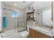 Well-lit bathroom with a shower-tub combo, a granite vanity top, and decorative shelving and accents at 24343 Pirate Harbor Blvd, Punta Gorda, FL 33955