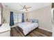 Serene bedroom with a ceiling fan, a comfortable bed, and a window with natural light and bright curtains at 24343 Pirate Harbor Blvd, Punta Gorda, FL 33955